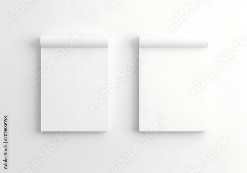 Two isolated top bound blank white notebooks for branding mockups, stationery design, office supplies, clean paper texture