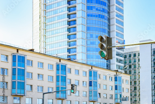 Urban traffic signal displaying green light for vehicles.