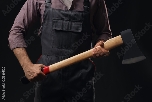 Konstfotografi Handsome lumberjack with ax on dark background, closeup