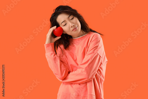 Young Asian woman with hear...