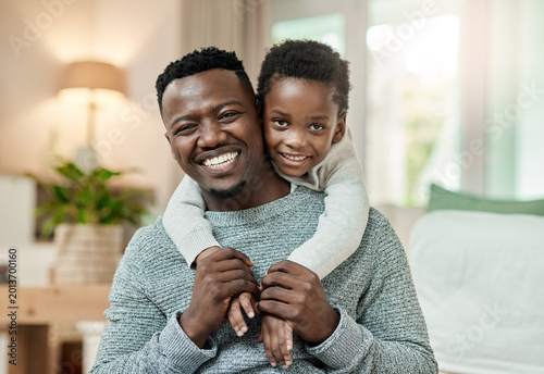 Photos Portrait, dad and smile with child in lounge, piggyback and bonding with son and connection in home