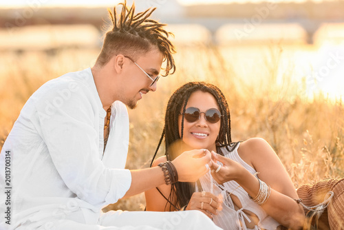 Foto Young couple of hippies with dreadlocks smiling outdoors
