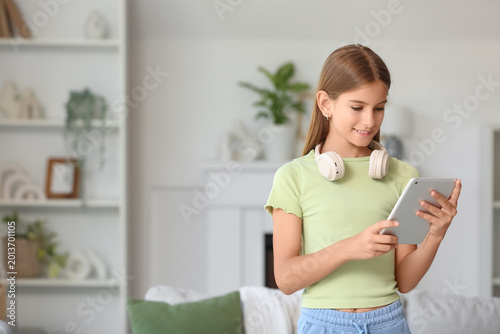 Teenage girl using tablet c...