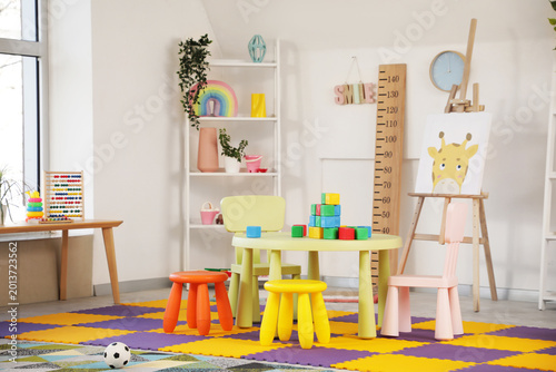 Fotografía Interior of stylish playroom with toys and easel in kindergarten