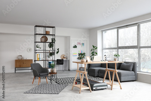 Workplace and treadmill in interior of light room