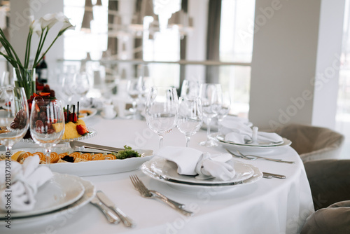 Elegant dining setup with food and drinks at a modern restaurant in the daytime