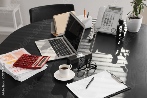 Laptop with coffee cup, tel...