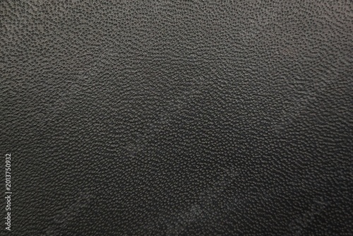 Dark black pebbled leather texture background for industrial product design.