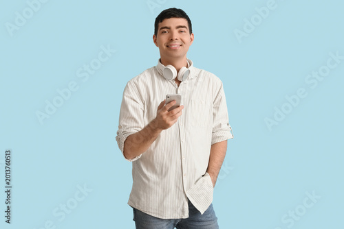 Happy young man using mobil...