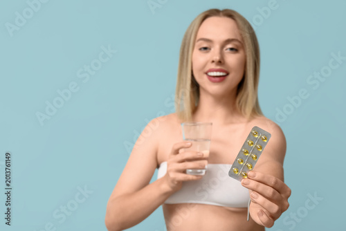 Young woman with vitamin A ...