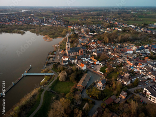 Quadro su tela Aerial View of a Flemish Town: Historic Church and Residential Areas by the Rive