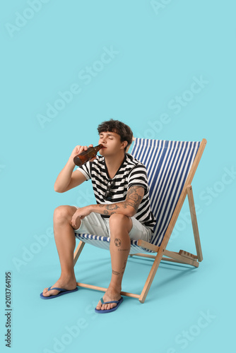 Young man drinking beer in ...