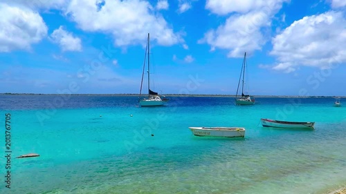 Sailboats, yachts and small fishing boats in tropical caribbean paradise. Sailing boats near the beach, serene footage from exotic vacation. Beach and sea on the exotic island.