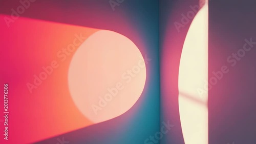 Abstract circular light projections illuminating a corner wall, casting vibrant color gradients and soft shadows, creating a minimalist yet dynamic visual effect