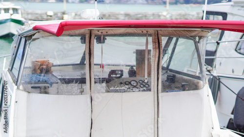 Valokuva The enclosed cockpit of a boat with a red canopy and transparent covers