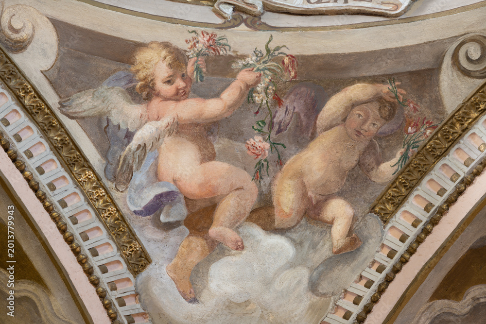 Fototapeta premium CREMA, ITALY - MARCH 20, 2026: The fresco of angels with the flowers the church Santuario di Santa Maria della Croce by Giacomo Parravicino - il Gianolo (1702).