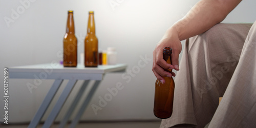 Man struggling with alcohol addiction and mental health issues at home