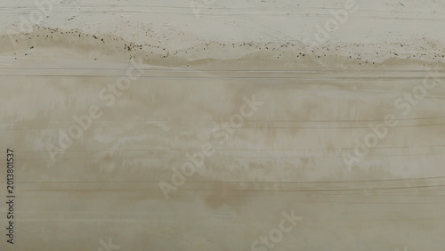 Tableau sur toile Aerial Top Down View of Sandy Beach with Tire Tracks