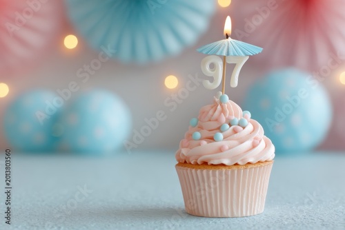 Festive cupcake with candle and decorative backdrop for birthday celebration