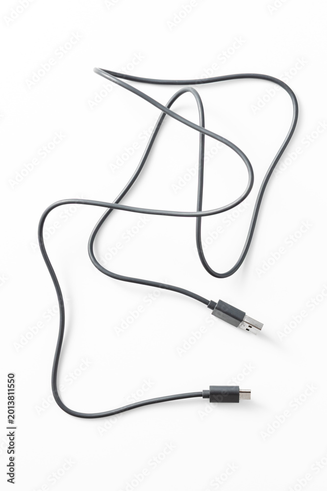 Obraz premium Black USB cable on white backdrop, tangled and disorganized