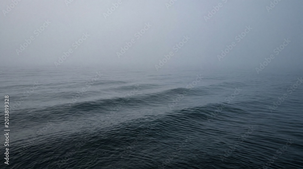 Fototapeta premium Professional Dense Morning Mist Hanging Over Gently Rolling Ocean Sweeping Dramatic Seascape Photography Image