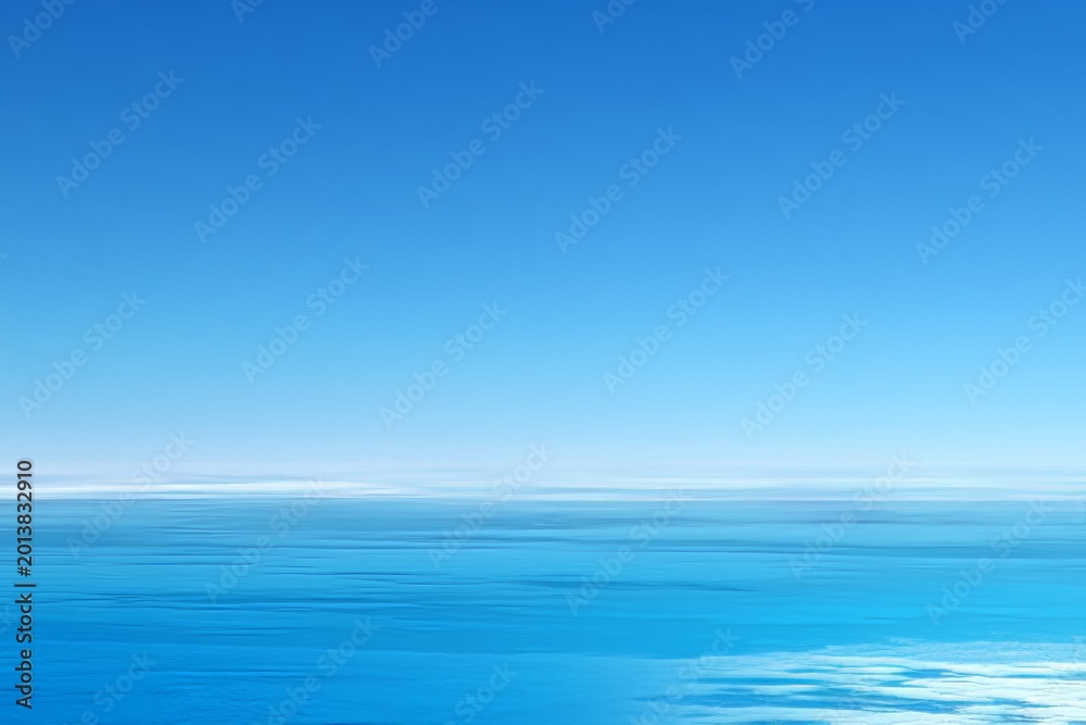 Obraz premium Tranquil ocean and clear blue sky horizon with soft clouds