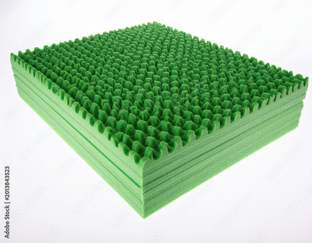 Fototapeta premium Stacked green foam egg crate mattress pad with textured surface on white background