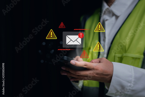 Spam Email. Cybersecurity alert, engineer using smartphone with warning notification icons, digital communication risk and data protection concept