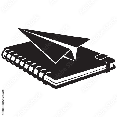 Black silhouette of a spiral-bound notebook with a diagonal paper airplane resting on top, symbolizing creativity, imagination, and learning.