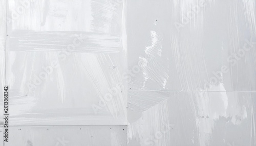 White painted texture on wall surface with brush strokes.