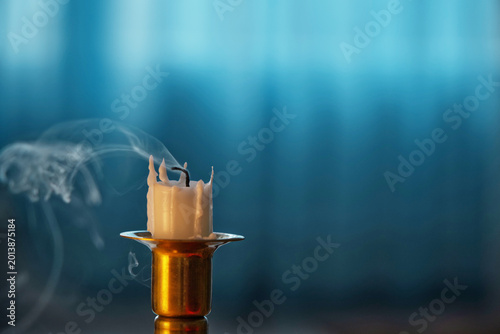 Photos Close-up of an extinguished candle on a candlestick, depth of field