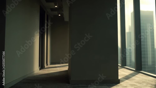 Interior office with soft carpeting and abundant natural light from floor to ceiling windows, offering expansive city views, modern minimalist design and calm, professional ambiance
