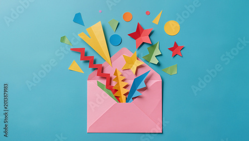 Colorful Paper Shapes Exploding from Pink Envelope on Blue Background