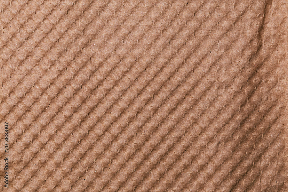 Fototapeta premium Textured Brown Paper Surface with Diagonal Raised Ribbed Pattern for Background