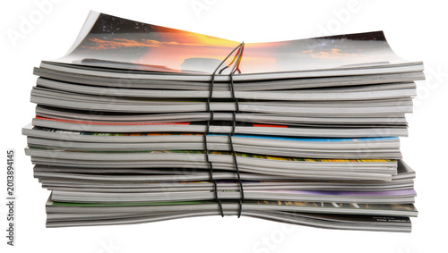 Obraz na plátně Isolated stack of colorful glossy magazines and periodicals tied securely with a