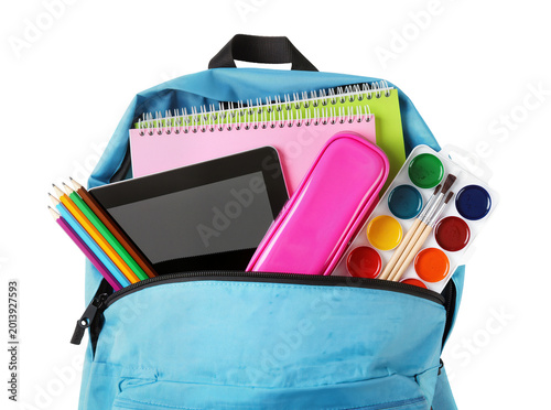 Isolated blue school backpack packed with colorful education and art supplies for children
