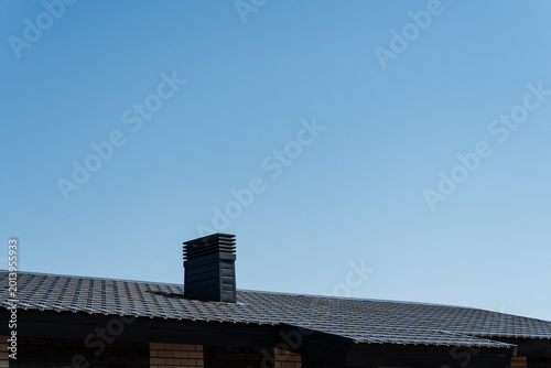 Sunlit Suburban Roof Outline. Peaceful Sky Scene Featuring Rooftop Chimney And Textures. Serene Dawn Landscape Highlighting Distinct Chimney Shape And Textured Rooftop Surfaces