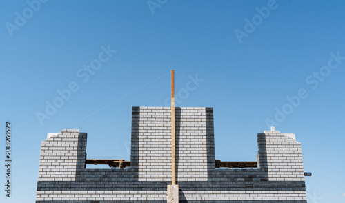 Canvas Print Unfinished Concrete Framework Stands Tall Against Bright Blue Background
