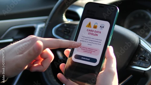 Man Seeing Card Data Stolen Alert on Smartphone in Car. High-impact footage of a Card Data Stolen warning on a phone. Perfect for content about identity theft, financial fraud, and cybersecurity.