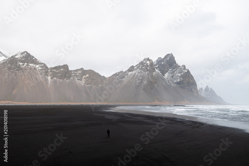 Black beaches in Iceland with a beautiful mountain in the back.