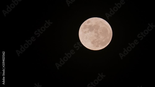 Full Moon Glowing in Dark Night Sky