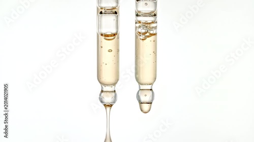 Drops of Essential Oil, Cosmetic Serum Fluid Gel With Bubbles Dripping From a Glass Pipette. Dermatology science laboratory. Macro Shot of Organic Skin or Body Care Products. High quality 4k 
