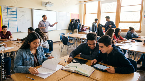Students studying together in modern high school classroom
