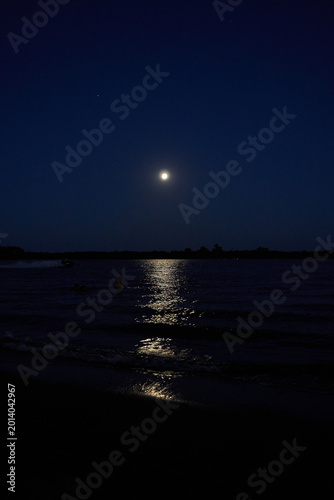 Full moon reflected over calm night river