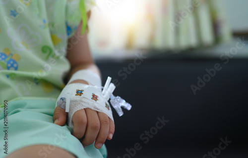 Canvastavla Close-up of sick child's hand with intravenous (IV) drip and bandage in hospital room, pediatric medical care and health insurance concept with copy space
