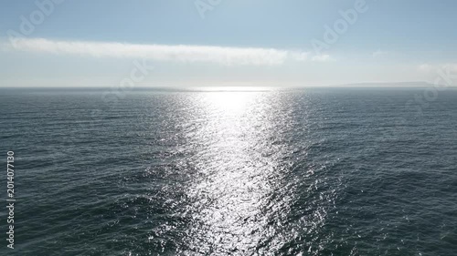 Top View Slow motion looping c ripples and wave, Refraction of sunlight top view texture sea side, Foaming and Splashing in the Ocean, Sunny Day, Slow Motion. Halkidiki, Greece. Veiw from drone
