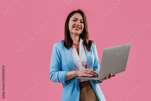 Young businesswoman smiling and holding a digital tablet