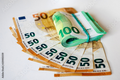 Top view of assorted euro banknotes on light background in organized arrangement. Concept budgeting and banking.
