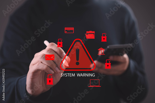 Cyber security warning concept with system alert interface, hand using smartphone and stylus highlighting data breach risk, privacy protection, hacking threat, digital security and network protection