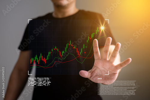 Businessman analyzing financial stock market growth chart with digital trading interface and rising candlestick data.